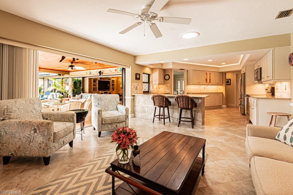 2308 Kings Lake Boulevard Naples, FL 34112 - Photo 15 of 36 a living room with furniture and view of kitchen