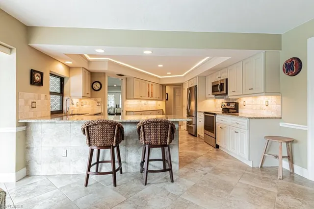 a living room with furniture a dining table and chairs