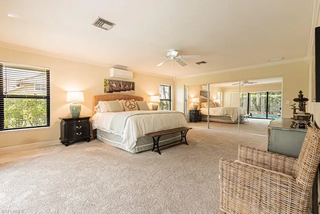 a spacious bedroom with a bed a couch and a window