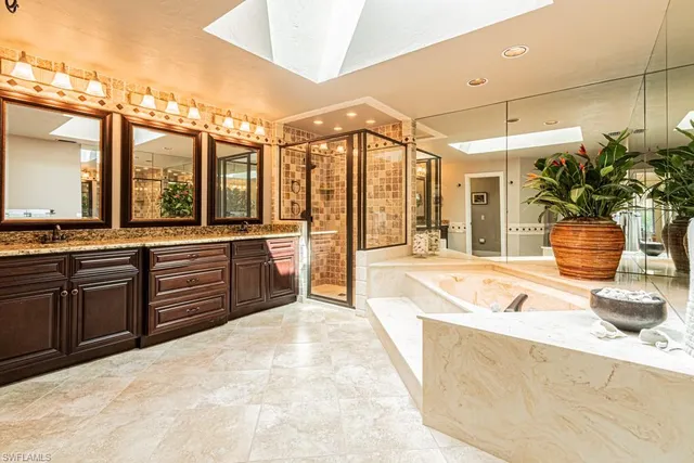 a large white kitchen with a large window
