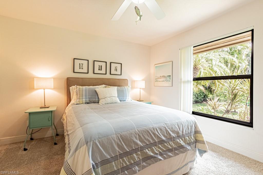 2308 Kings Lake Boulevard Naples, FL 34112 - Photo 23 of 36 a bedroom with a bed and window