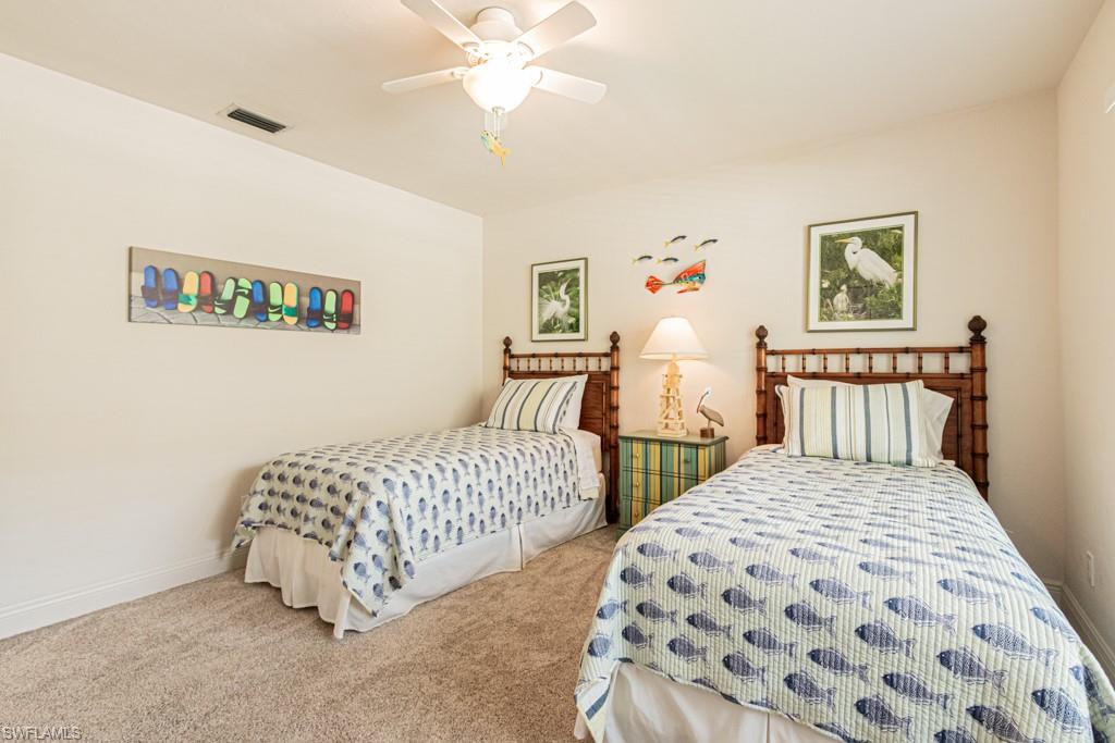 2308 Kings Lake Boulevard Naples, FL 34112 - Photo 25 of 36 a bedroom with two beds and a table