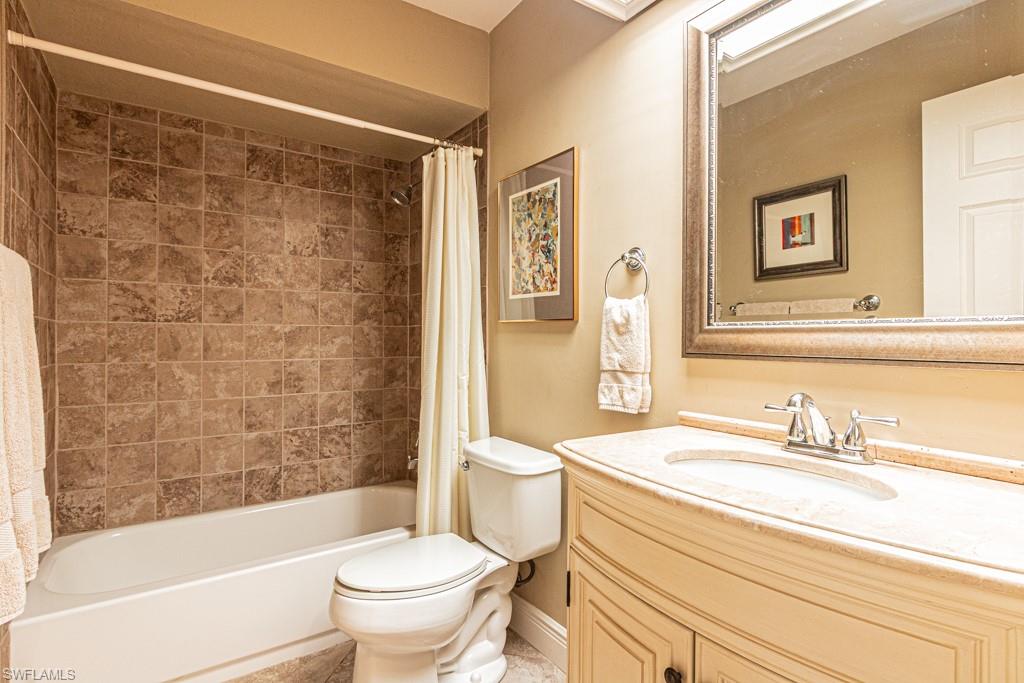 2308 Kings Lake Boulevard Naples, FL 34112 - Photo 26 of 36 a bathroom with a sink a toilet and a bathtub