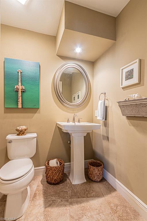 2308 Kings Lake Boulevard Naples, FL 34112 - Photo 36 of 36 a bathroom with a toilet and a mirror