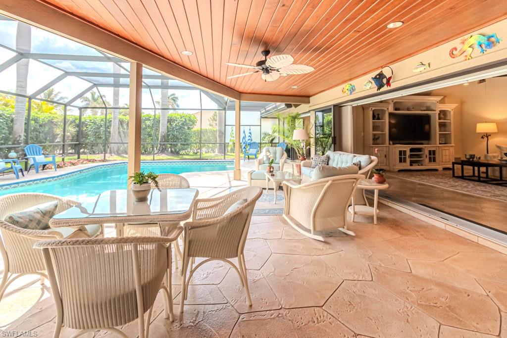 2308 Kings Lake Boulevard Naples, FL 34112 - Photo 30 of 36 a dining room with furniture water view and large windows