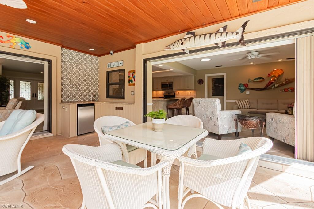 2308 Kings Lake Boulevard Naples, FL 34112 - Photo 31 of 36 a view of a dining room with furniture and wooden floor