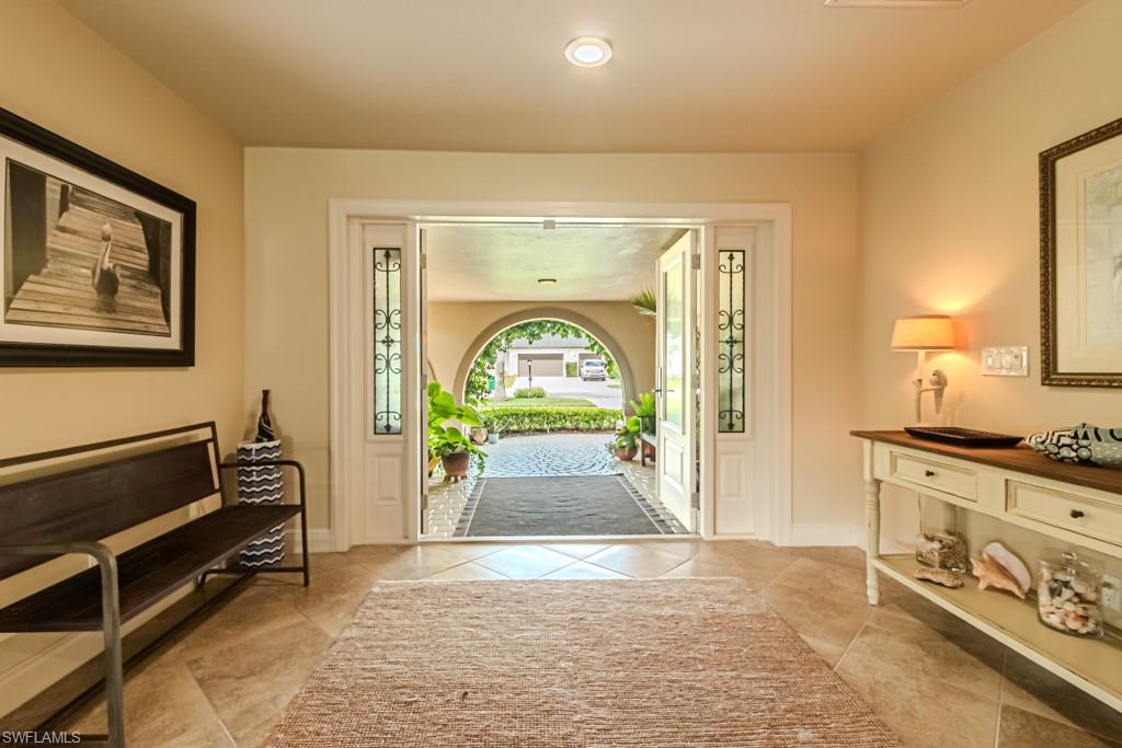 2308 Kings Lake Boulevard Naples, FL 34112 - Photo 6 of 36 a hallway with a stove and a couch