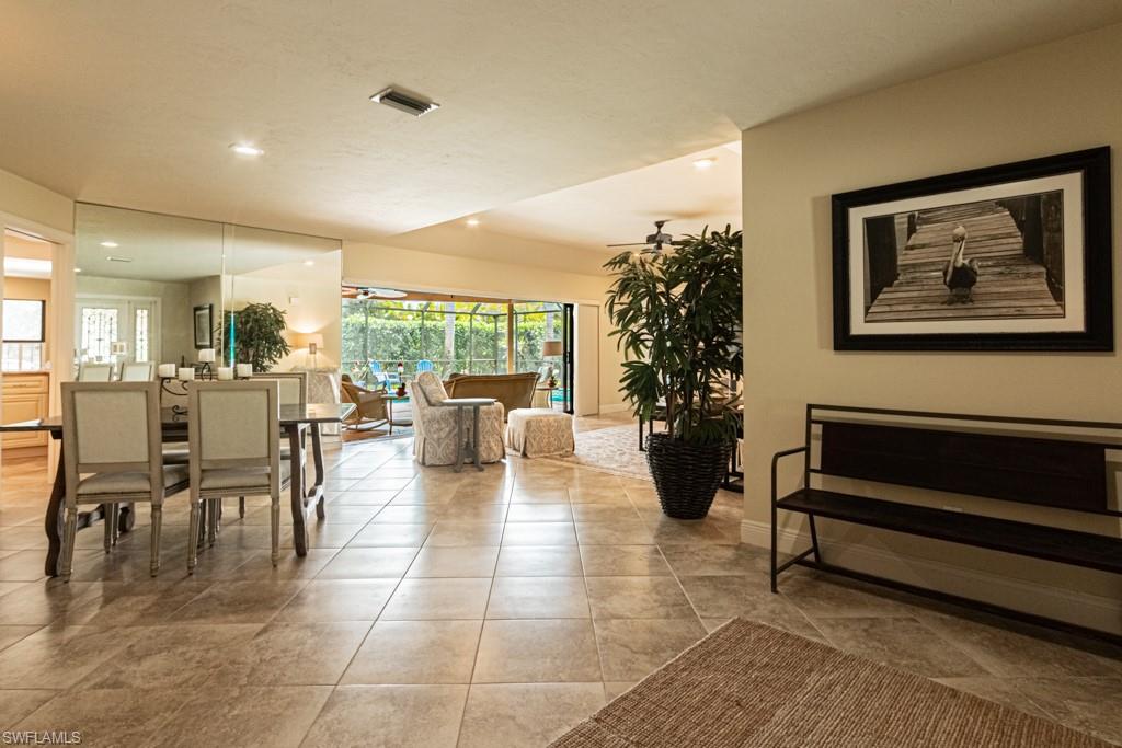 2308 Kings Lake Boulevard Naples, FL 34112 - Photo 8 of 36 a living room with furniture and a potted plant