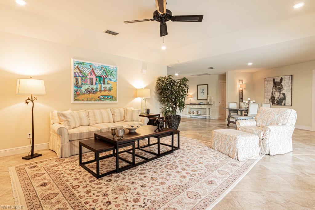 2308 Kings Lake Boulevard Naples, FL 34112 - Photo 9 of 36 a living room with furniture and a rug