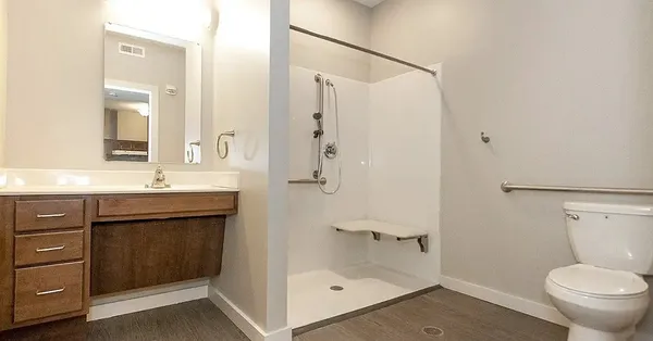 a bathroom with a granite countertop sink toilet and shower