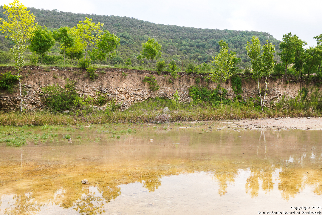 35298 Ranch To Market Road 187 Vanderpool, TX 78885 - Photo 13 of 29 a view of lake with a mountain in the background