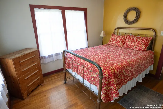 a bed sitting in a bedroom next to a window