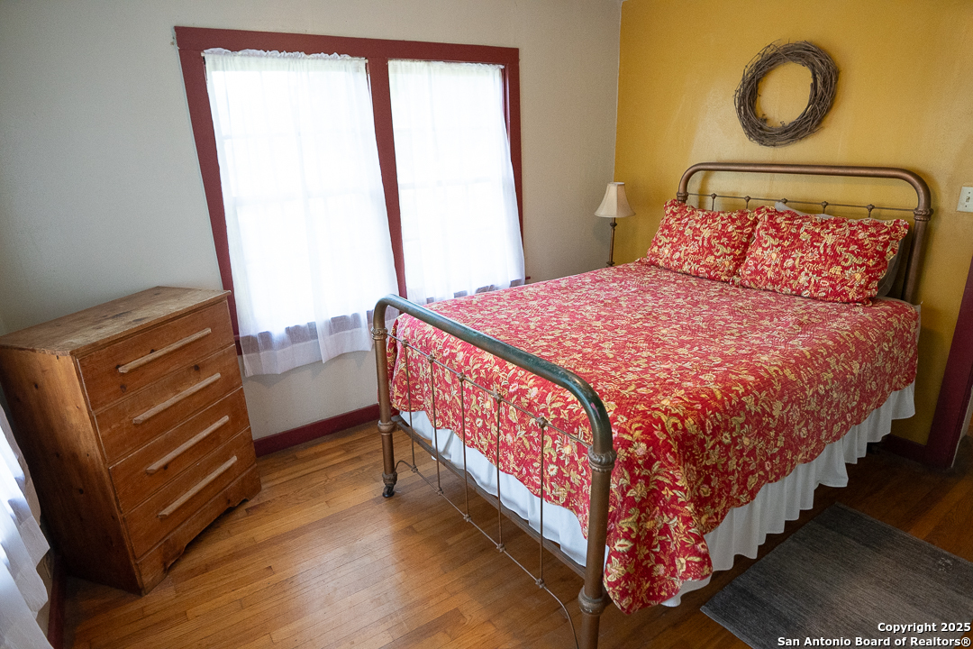 35298 Ranch To Market Road 187 Vanderpool, TX 78885 - Photo 22 of 29 a bed sitting in a bedroom next to a window
