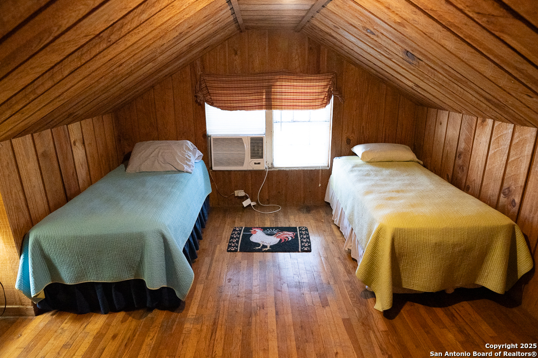 35298 Ranch To Market Road 187 Vanderpool, TX 78885 - Photo 25 of 29 a bed sitting in a bedroom next to a window