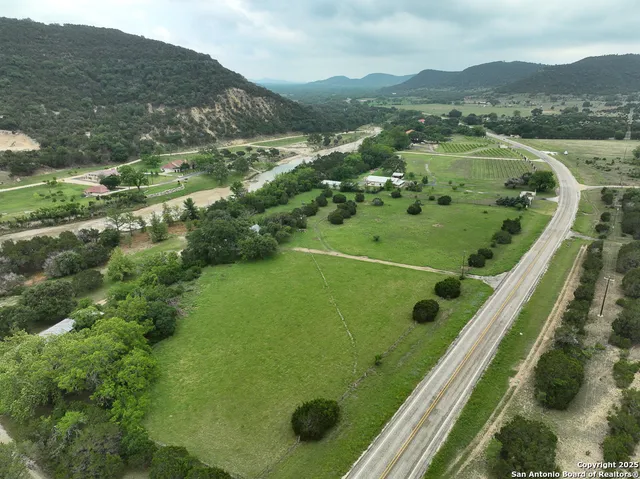 a view of a lush green hillside and houses
