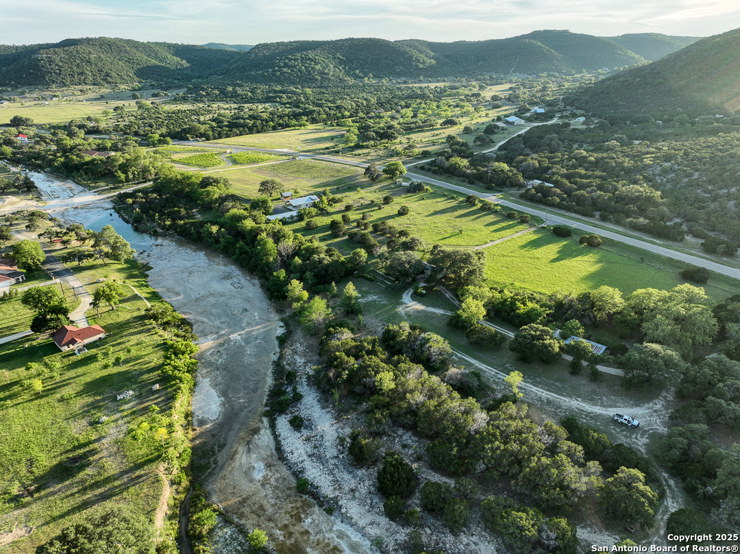 35298 Ranch To Market Road 187 Vanderpool, TX 78885 - Photo 5 of 29 a view of a lush green hillside and houses