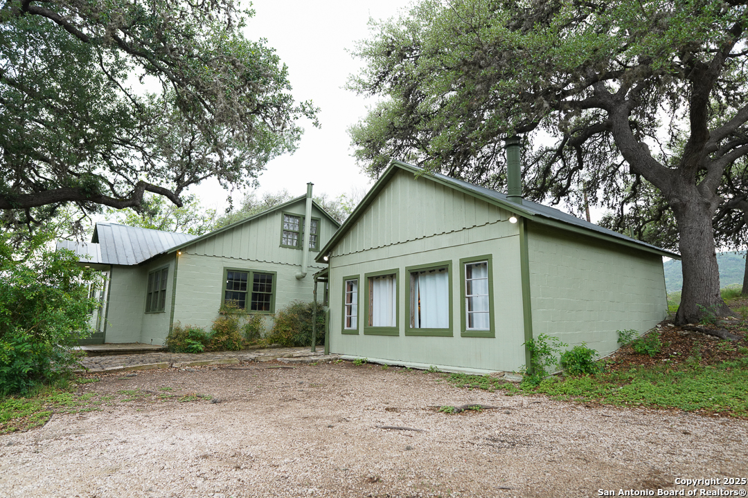 35298 Ranch To Market Road 187 Vanderpool, TX 78885 - Photo 9 of 29 a house with trees in the background