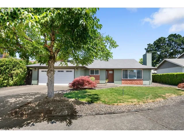 a front view of a house with a garden and yard