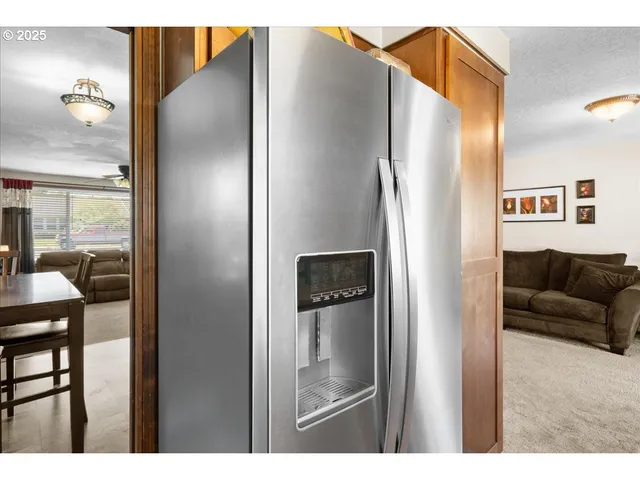 a bathroom with a refrigerator and a mirror