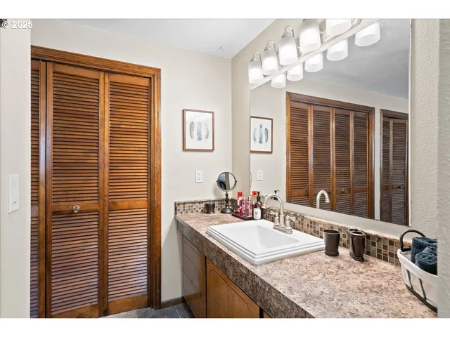 a bathroom with a sink a mirror and a shower