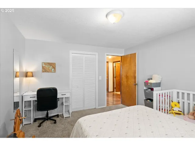 a bedroom with a bed and a chair