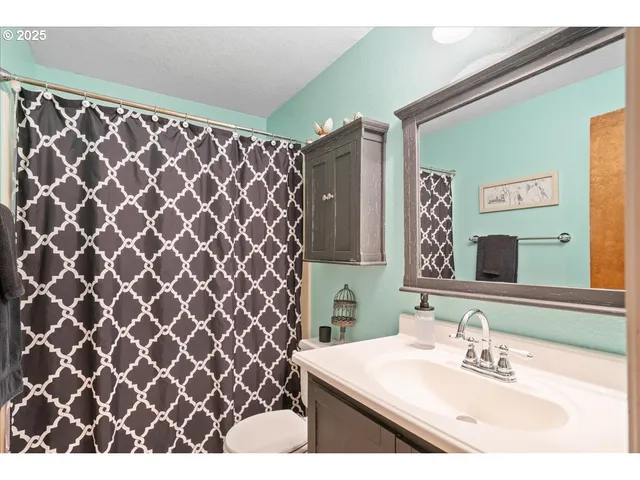 a bedroom with a bed a desk and a window