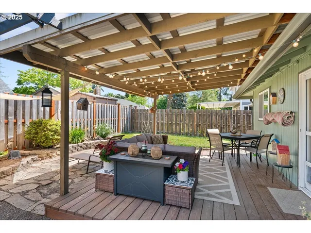 a view of a patio with a table and chairs under an umbrella