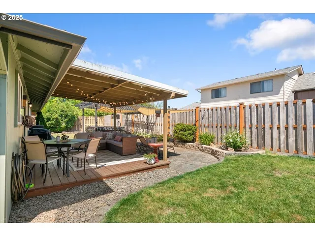 a view of a house with backyard porch and sitting area