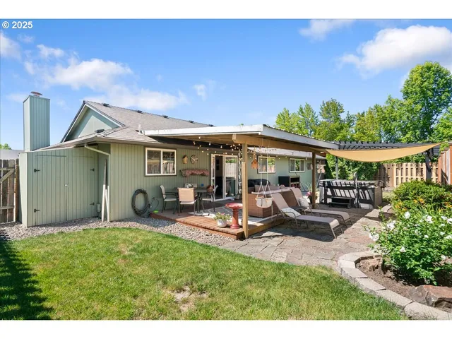 a view of a house with backyard porch and sitting area
