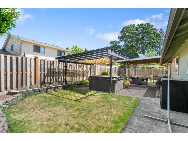 a view of a house with backyard and sitting area