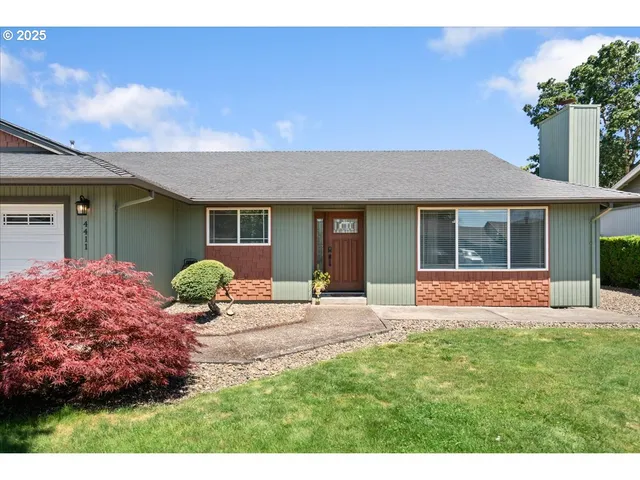 a front view of a house with a yard and porch