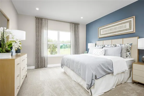 a spacious bedroom with a large bed and a window