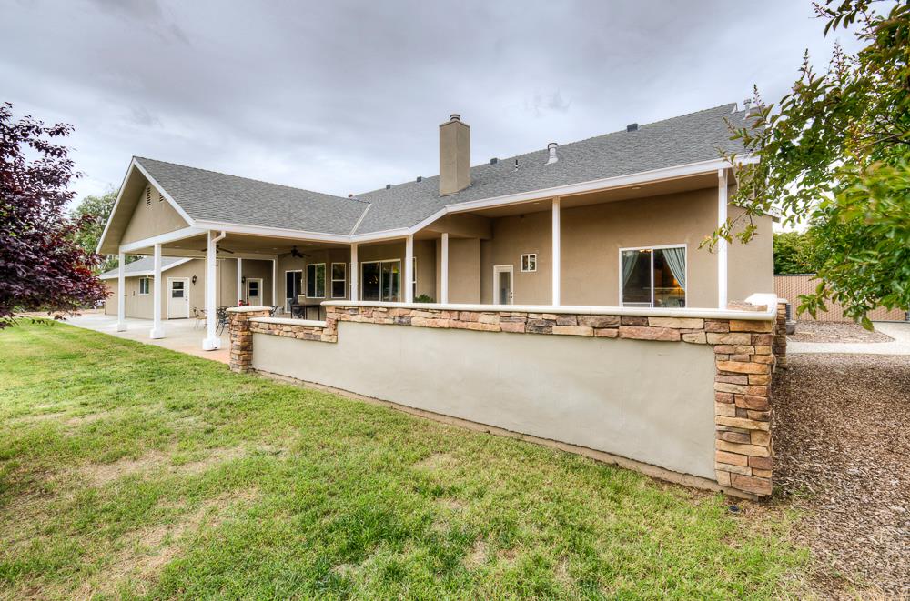 17465 Monreal Road Madera, CA 93636 - Photo 11 of 59 a front view of a house with swimming pool and porch