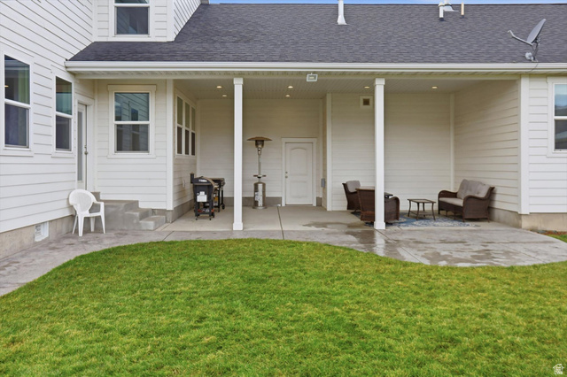 1009 High Creek Road Cove, UT 84320 - Photo 64 of 79 Rear view of house featuring a patio, a shingled roof, and a yard