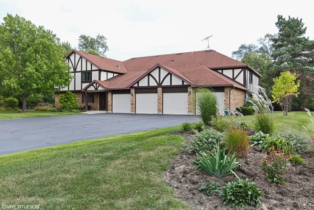 523 Banyon Lane, Unit A La Grange, IL 60525 - Photo 1 of 10 a view of a big house with a big yard and large trees