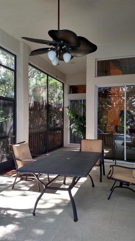 8526 Peppertree Way Naples, FL 34114 - Photo 13 of 14 a living room with patio furniture and a floor to ceiling window