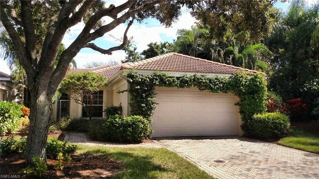 8526 Peppertree Way Naples, FL 34114 - Photo 3 of 14 a front view of house with yard and trees