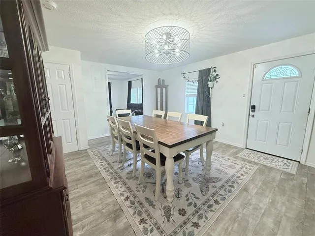 a view of a dining room with furniture and window