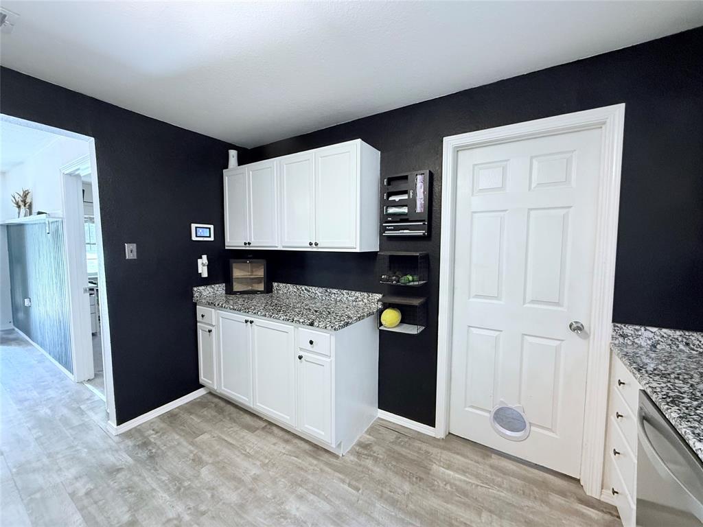 532 Marquette Avenue Azle, TX 76020 - Photo 21 of 32 a kitchen with granite countertop a refrigerator and a stove