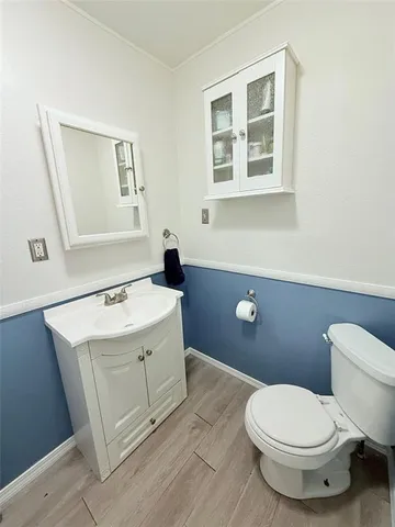 a bathroom with a sink a toilet and mirror