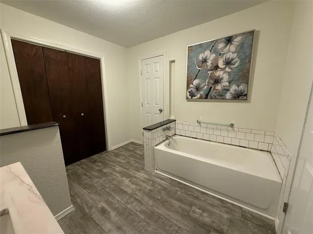 a bathroom with a bathtub and a shower