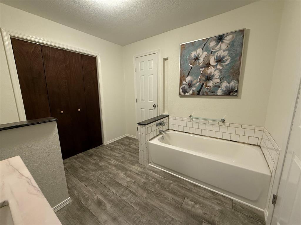 532 Marquette Avenue Azle, TX 76020 - Photo 28 of 32 a bathroom with a bathtub and a shower