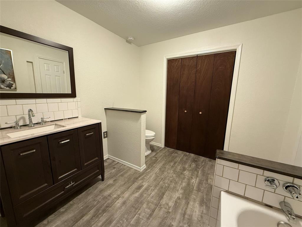 532 Marquette Avenue Azle, TX 76020 - Photo 29 of 32 a spacious bathroom with a double vanity sink and mirror