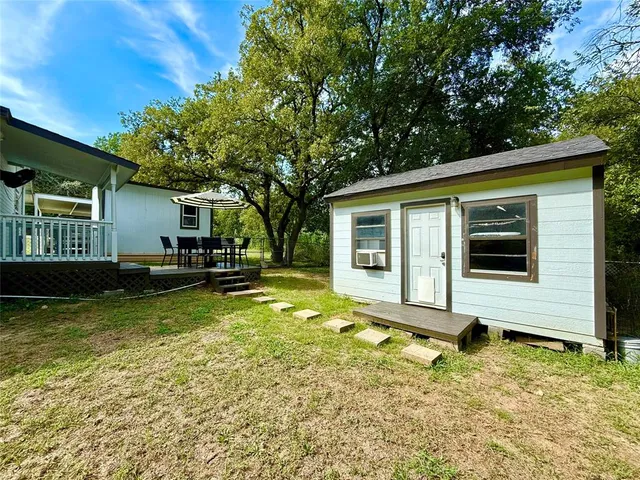 a view of house with backyard and swimming pool