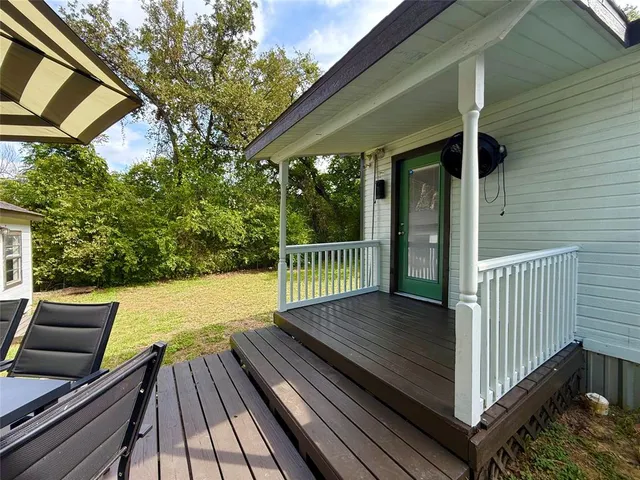 a view of balcony with wooden floor and fence