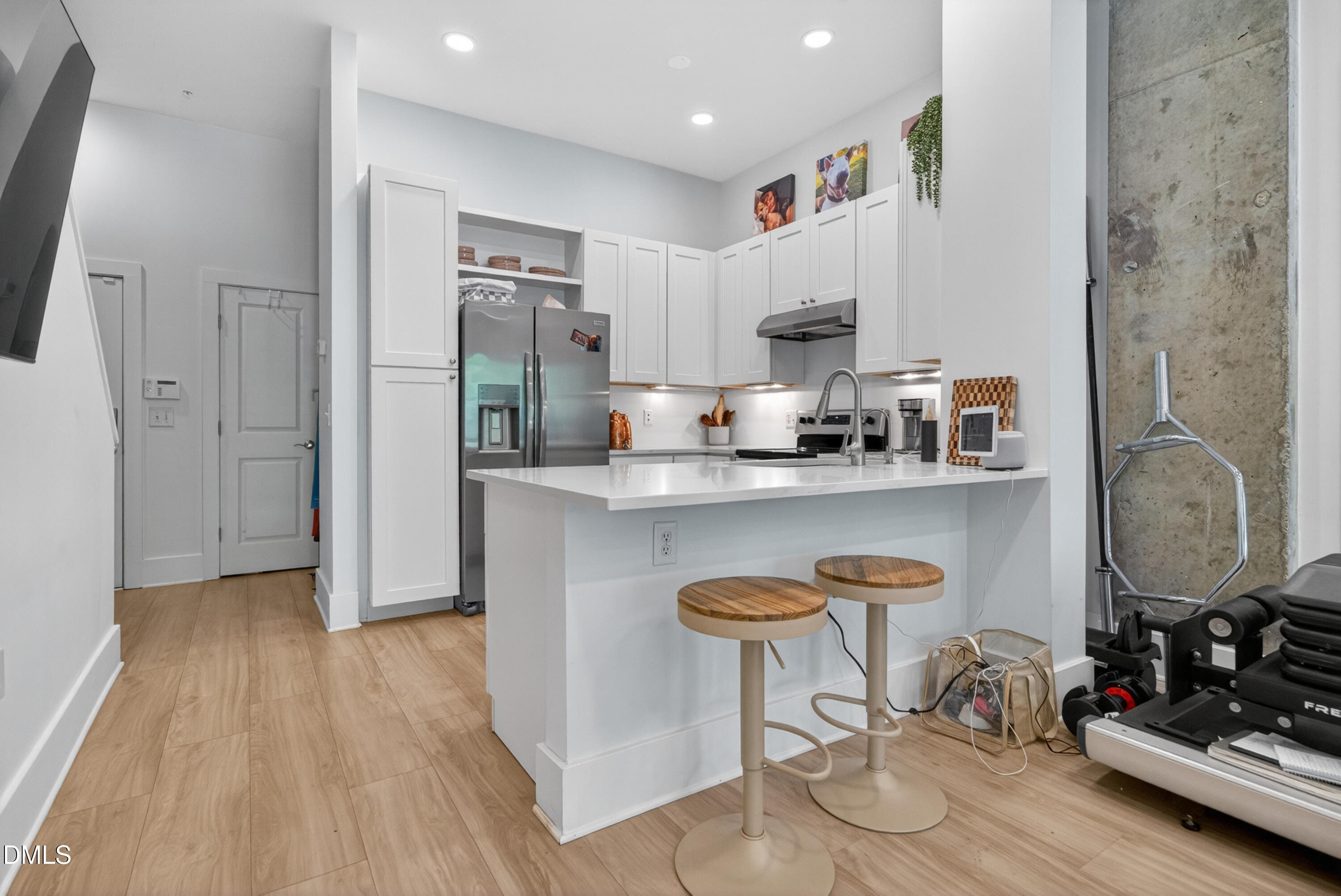 444 South Blount Street, Unit 111 Raleigh, NC 27601 - Photo 20 of 40 a kitchen with stainless steel appliances granite countertop a sink refrigerator and cabinets