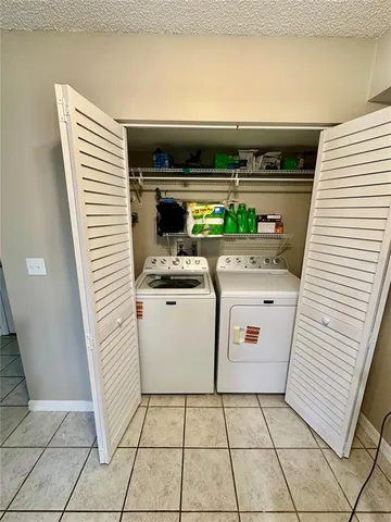 a view of a hallway with wooden floor and a chandelier
