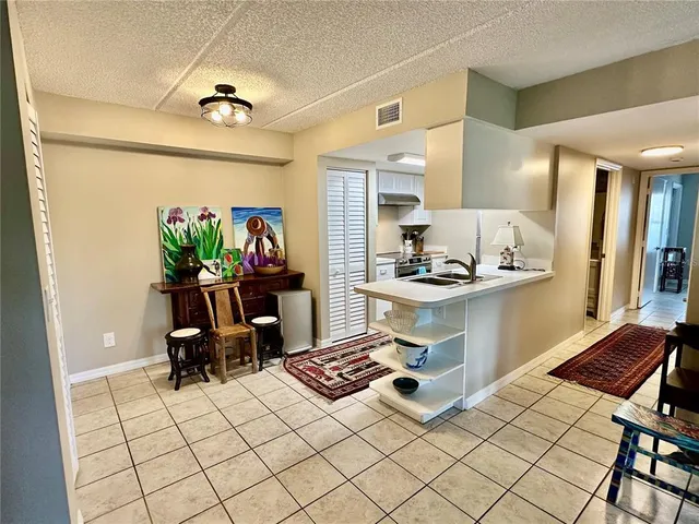 a kitchen with wooden cabinets stove and washing machine