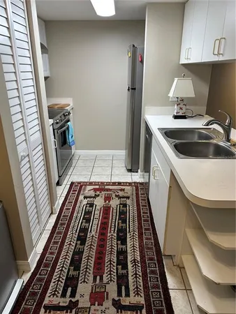 a kitchen with a sink and white cabinets