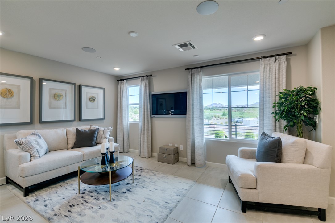 653 Pickled Pepper Place Henderson, NV 89011 - Photo 6 of 35 Natural light floods this living space, highlighting its generous proportions and serene mountain views.